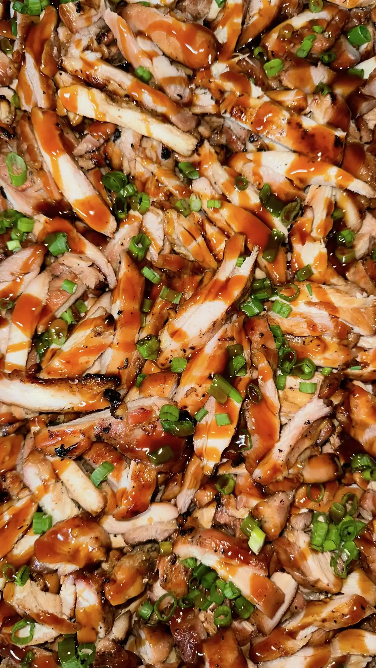Tray of freshly grilled teriyaki chicken with green onion